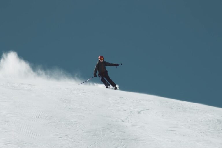 Thrilling shot of a skier carving through snow in Sölden, Austria on a bright winter day.