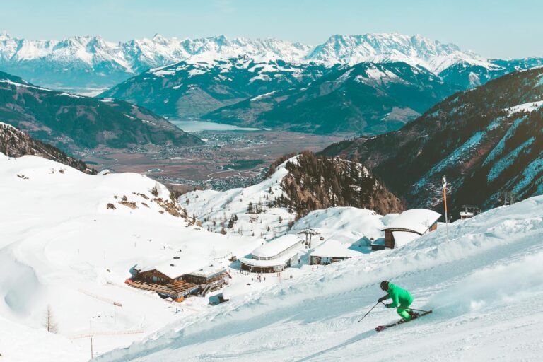 A skier enjoying the snowy slopes with stunning views of the Kaprun Alps in Austria.