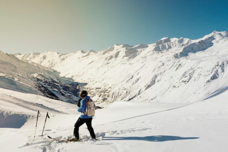 A skier enjoying a sunny day on snow-covered slopes in Gurgl, Austria.